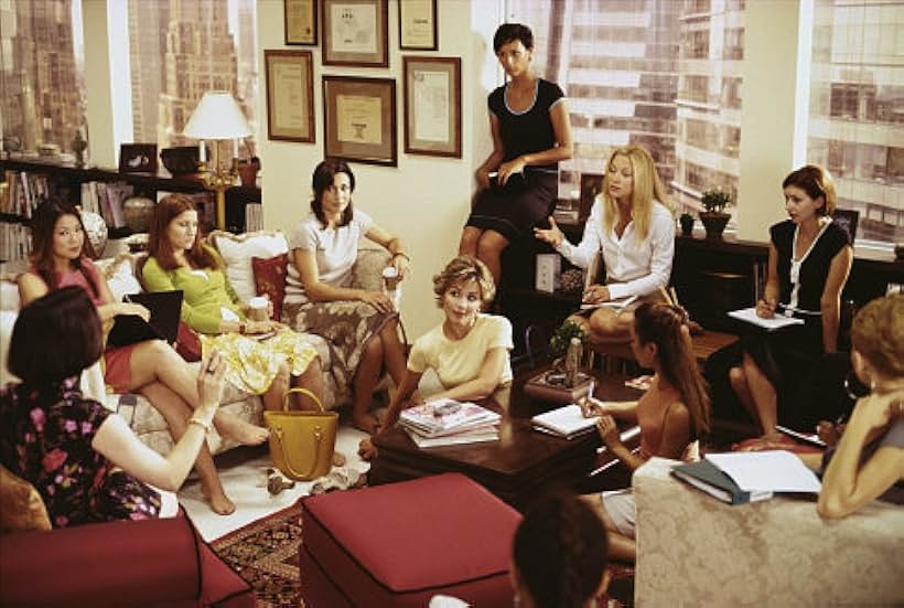 (Far left corner) Bebe Neuwirth as Lana, (on couch center) Kathryn Hahn as Michelle, (on couch right) Annie Parisse as  Jeannie, (right center white top) Kate Hudson as Andie 