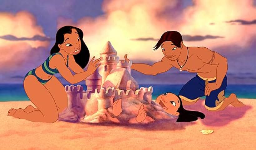 Nani (left) and her former boyfriend David Kawena (right) enjoy a happy moment as they play in the sand with Lilo.