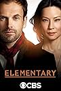 Jonny Lee Miller and Lucy Liu in Điều Cơ Bản (2012)