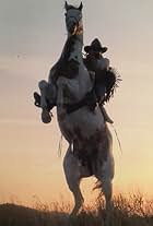 Jay T. Rockwell poses for portrait with his 250 trick horse, Legend, in a photo taken for Clint Eastwood