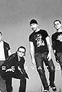 Bono, Adam Clayton, Larry Mullen Jr., The Edge, and U2 in U2: Elevation (2001)