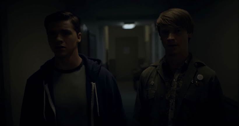 Calum Worthy and Joel Courtney in Assimilate (2019)