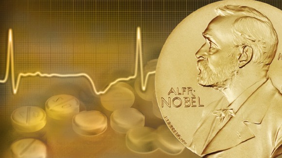 Nobel prize medal in front of some tablets and a graph showing heart rate.